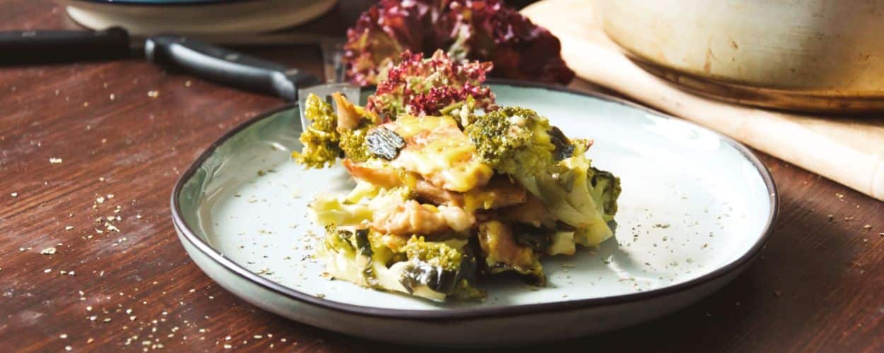 Veganer Brokkoli Auflauf, goldbraun gebacken mit cremiger Sauce, angerichtet auf einem Teller.